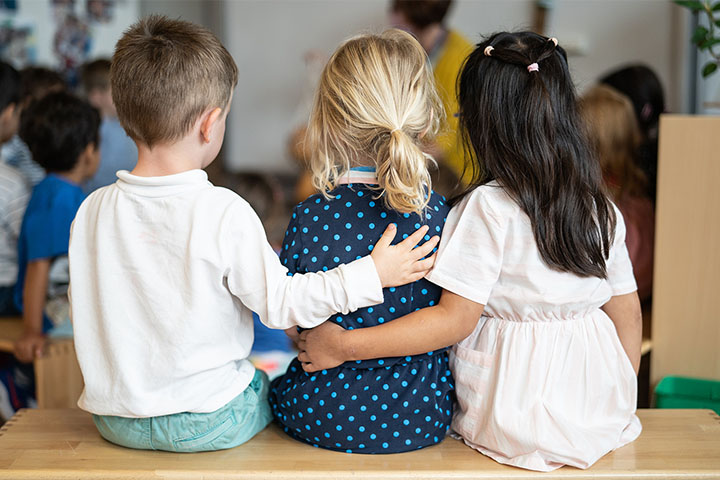 Children holding each other for inclusion